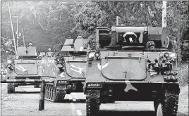  ?? [BULLIT MARQUEZ/THE ASSOCIATED PRESS] ?? Tanks arrive at a camp in Iligan in the southern Philippine­s to reinforce government troops battling Muslim militants who have laid siege to Marawi city for more than a week.