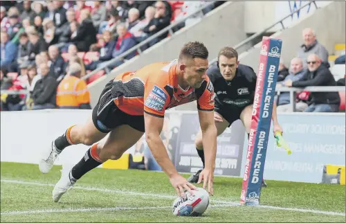  ??  ?? TRY: Castleford Tigers’ Greg Eden crashes over for one of four tries he scored against Leigh Centurions yesterday in Super League. PICTURE: PAUL CURRIE/SWPIX.COM