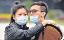  ?? REUTERS ?? A couple embrace each other while observing a flag raising ceremony at Chiang Kai Shek Memorial Hall in Taipei, Taiwan on Wednesday.