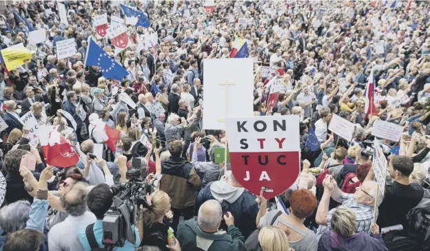  ??  ?? 0 Hundreds of people demonstrat­e to support the Supreme Court president in front of the Supreme Court building in Warsaw
PICTURE: GETTY IMAGES