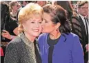  ??  ?? In this Sept 10, 2011 file photo, Carrie Fisher kisses her mother, Debbie Reynolds, as they arrive at the Primetime Creative Arts Emmy Awards in Los Angeles.