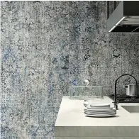  ?? Associated Press ?? ■ Del Conca's Timeline collection puts the look of distressed vintage carpet on tile.