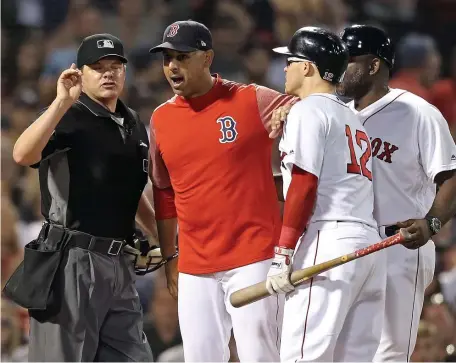  ?? MATT STONE / BOSTON HERALD ?? HIT THE SHOWERS: Alex Cora argues with home plate umpire D.J. Reyburn after the ejection of Brock Holt (12) in the third inning last night at Fenway Park.