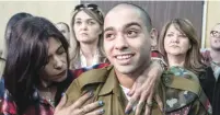  ?? (Jim Hollander, pool/Reuters) ?? ELOR AZARIA is hugged by his mother in a military court in Tel Aviv on February 21 during hearings on his sentencing.