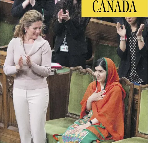  ?? ADRIAN WYLD / THE CANADIAN PRESS ?? Sophie Grégoire Trudeau joins in the standing ovation for Malala Yousafzai in the House of Commons Wednesday.