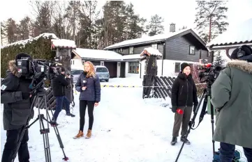  ?? — Reuters photo ?? Members of the media work outside the house of in Fjellhamar, Norway.