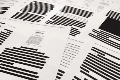  ?? AP photo ?? Pages from the affidavit by the FBI in support of obtaining a search warrant for former President Donald Trump’s Mar-a-Lago estate are photograph­ed Friday. U.S. Magistrate Judge Bruce Reinhart ordered the Justice Department to make public a redacted version of the affidavit it relied on when federal agents searched Trump’s estate to look for classified documents.