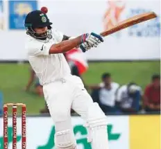  ?? Rex Features ?? Virat Kohli plays a pull shot during the first day of the opening Test against Sri Lanka at Galle Stadium in Sri Lanka.