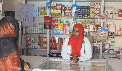 ?? MATTHEW VICKERY ?? The day begins at 5 a.m. for Sahra Ali, talking to a customer in the pharmacy she runs in Hargeisa, Somalia.