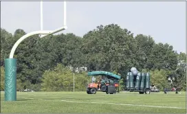  ?? ADAM HUNGER — THE ASSOCIATED PRESS ?? Jets personnel clear equipment after practice was canceled at the NFL football team’s training camp in Florham Park on Thursday. The Jets canceled their practice in an apparent response to the shooting of Jacob Blake, a Black man, in Wisconsin.