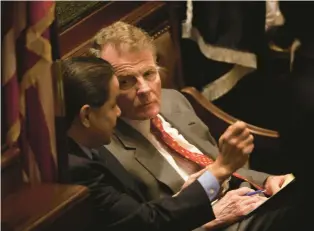  ?? E. JASON WAMBSGANS/CHICAGO TRIBUNE ?? House Speaker Mike Madigan confers with Rep. Edward Acevedo on the bench behind the speaker’s podium in the House chambers in Springfiel­d in 2010.