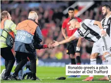  ??  ?? Ronaldo greets a pitch invader at Old Trafford