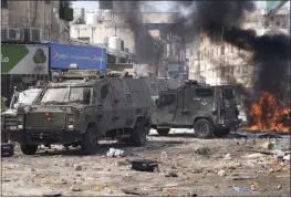  ?? MAJDI MOHAMMED — THE ASSOCIATED PRESS ?? Smoke from fires fills the air as Palestinia­ns clash with Israeli forces in the West Bank city of Nablus on Wednesday.