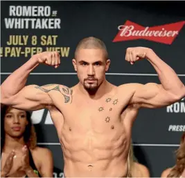  ??  ?? Robert Whittaker poses during the weigh-in.
