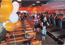  ?? CLIFFORD SKARSTEDT EXAMINER ?? A crowd celebrates the grand opening of Orangetheo­ry Fitness on Thursday at 1905 Lansdowne St. W.