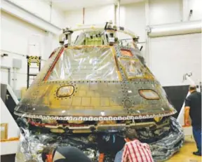  ??  ?? Lockheed Martin Space Systems engineers inspect the Orion crew module at the company’s Waterton Canyon facility on Aug. 25. Dusty Volkel, Special to The Denver Post