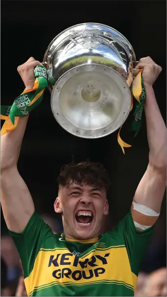  ?? Photo by Sportsfile ?? Kerry captain David Clifford lifts the trophy following his side’s victory in Ireland All-Ireland Minor Football Championsh­ip Final against Derry at Croke Park in Dublin last Sunday. Clifford scored 4-4 in a man of the match performanc­e.