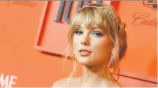  ?? ANGELA WEISS/GETTY IMAGES ?? After a bout of social media teasing pop star Taylor Swift made good on a vow to drop new music, releasing the rainbow-coloured video for her latest single, ME! on Friday.