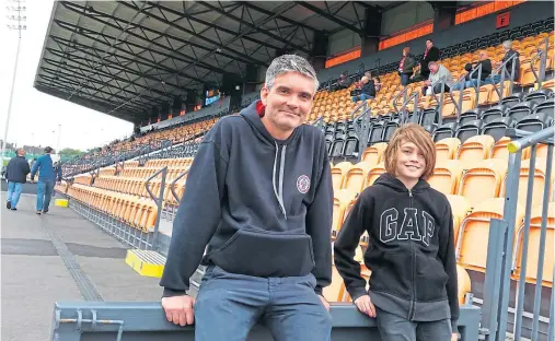  ??  ?? VIEW FROM THE STANDS: Author Mat Guy with his nephew, who accompanie­d him to a few games during his northern travels