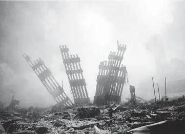  ?? ALEXANDRE FUCHS/AP ?? The remains of the World Trade Center stand Sept. 11, 2001, following the terrorist attack in New York.