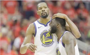  ?? AP ?? Kevin Durant ( left) and Draymond Green celebrate during their Game 7 victory Monday against the Rockets.