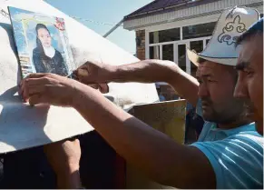  ?? — AFP ?? Crying for justice: Relatives of Kyzy holding a traditiona­l ceremony to honour her in the settlement of Sokuluk, northern Kyrgyzstan.