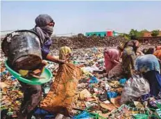  ?? AFP ?? Garbage scavengers look for reusable or recyclable material in a dump in Bamako. In the heart of the Malian capital, in the ACI business district, an immense dump is being evacuated following residents’ protests.