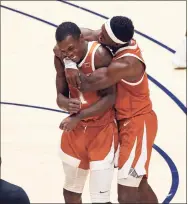  ?? Kathy Batten / Associated Press ?? Texas guards Andrew Jones (1) and Courtney Ramey (3) celebrate after Jones scored against West Virginia during the second half on Saturday in Morgantown, W.Va. Jones was playing for the first time since being diagnosed with leukemia two years ago.