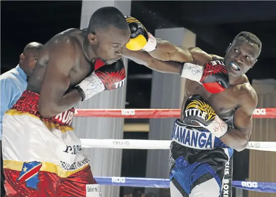  ?? / CHRISTO SMITH ?? Clement Kamanga, right, in action against Raymond Kupula in their bout at Turffontei­n Racecourse,Joburg.