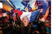  ?? FRANK AUGSTEIN / ASSOCIATED PRESS ?? Supporters of far-right leader Marine Le Pen in HeninBeaum­ont, northern France, celebrate after exit poll results showed the populist advancing to a runoff election May 7.