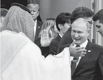  ?? HO / AFP / Getty Images ?? Saudi Arabia Crown Prince Mohammed bin Salman greets Russia President Vladimir Putin at the G-20 Summit last week. The two countries are considerin­g oil production cuts to lift crude prices.