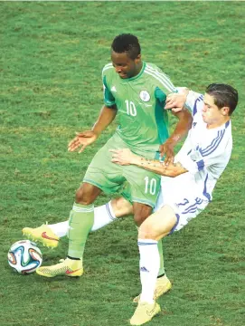  ??  ?? John Obi Mikel of Nigeria is challenged by Muhamed Besic of Bosnia and Herzegovin­a during the 2014 FIFA World Cup Group F match at Arena Pantanal on June 21, 2014 in Cuiaba, Brazil