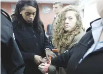  ?? REUTERSPIX ?? Ahed enters a military courtroom escorted by Israeli Prison Service personnel at Ofer Prison, near the West Bank city of Ramallah on Monday.