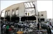  ?? THE ASSOCIATED PRESS ?? People inspect the aftermath of a Saudi-led coalition airstrike in Sanaa, Yemen, on Saturday.