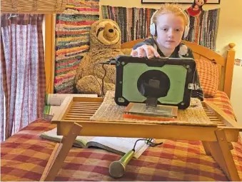  ?? CONTRIBUTE­D PHOTOS BY KAREN NAZOR HILL ?? Fifth-grader Evie Nazor, 10, does her virtual lessons twice a week in a bedroom at her grandparen­ts’ house.