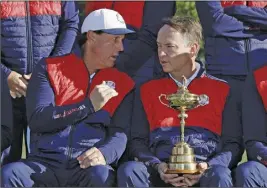  ?? Ap pHoto ?? Phil Mickelson (left) talks with Davis Love III during yesterday’s U.S. team picture for the Ryder Cup.