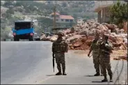  ?? (AP/Mohammed Zaatari) ?? Lebanese soldiers on Friday in the village of Shwaya stand next to a rocket launcher that was used by Hezbollah militants to fire projectile­s near Israeli positions. Video at arkansason­line.com/87lebanon/.