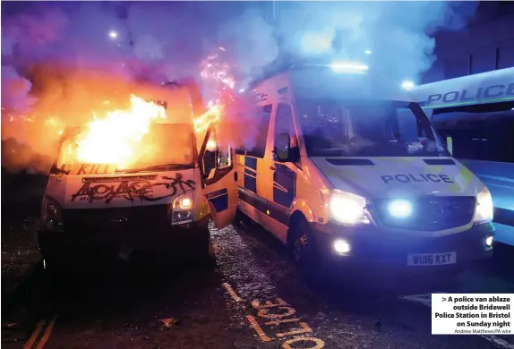  ?? Andrew Matthews/PA wire ?? > A police van ablaze outside Bridewell Police Station in Bristol on Sunday night