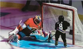  ?? AP ?? Former Florida Panthers goaltender Roberto Luongo attempts to stop a shot on goal by Sergei Ovechkin, 4, son of the Washington Capitals’ Alex Ovechkin, during the NHL All Star Skills Showcase on Friday in Sunrise. During the festivitie­s the NHL annonced a donation to renovate the outdoor rink at Holiday Park.