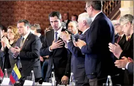  ?? AP/ MARTIN MEJIA ?? Flanked by Vice President Mike Pence (right center), Venezuela’s self-proclaimed interim president Juan Guaido, acknowledg­es the applause Monday during a meeting of the Lima Group concerning Venezuela at the Foreign Ministry in Bogota, Colombia.