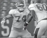  ?? NWA Media/MICHAEL WOODS ?? Arkansas offensive lineman Brey Cook gets set to block during a drill Saturday at Razorback Stadium.