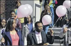  ?? BRANT SANDERLIN / BSANDERLIN@AJC.COM, ?? Mourners exit the memorial service before releasing balloons in memory of James Jones Jr., a Clark Atlanta University student.