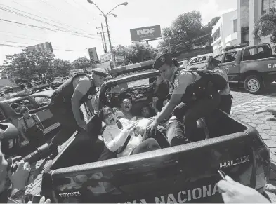  ?? ALFREDO ZUNIGA / THE ASSOCIATED PRESS ?? Anti-government protesters are taken away by police as security forces disrupt their march in Managua, Nicaragua, on Sunday. The protests, calling for President Daniel Ortega’s resignatio­n, have been ongoing since April.