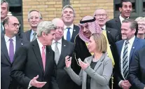  ?? Bertrand Guay / AP Photo ?? US secretary of state John Kerry with European Union foreign policy chief Federica Mogherini and other foreign ministers and representa­tives at the Paris talks.