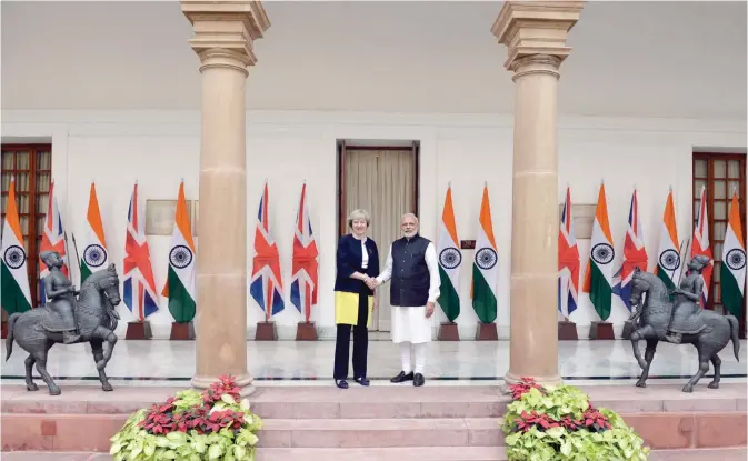  ?? — AFP ?? NEW DELHI: India’s Prime Minister Narendra Modi (right) shakes hands with Britain’s Prime Minister Theresa May prior to a meeting in New Delhi yesterday. Prime Minister Theresa May said Britain would become the ultimate free trade champion as she laid...