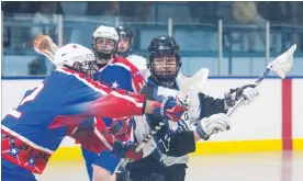  ?? JULIE JOCSAK
THE ST. CATHARINES STANDARD ?? Nickolas Carpenter of the Welland Generals tries to block Michael Wilson of the Niagara Thunderhaw­ks.