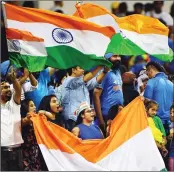  ??  ?? Indian fans celebrate after Team India's win over West Indies. (R) Mahendra Singh Dhoni (C) shake hands with West Indies Denesh Ramdin as Chris Gayle looks on after the match in Perth on Friday.