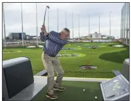  ?? (NWA Democrat-Gazette/Ben Goff) ?? Rich Davis of Northwest Arkansas swings Wednesday during the Taste and Tour preview event at Topgolf Northwest Arkansas in Rogers. Employees of local businesses had the opportunit­y to sample what the venue has to offer before it opens to the general public later in March. Go to nwaonline.com/200312Dail­y/ for today’s photo gallery.
