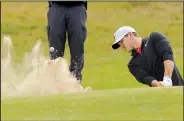  ?? AP/ALASTAIR GRANT ?? blasts out of the bunker on the 18th hole at Royal Birkdale during Thursday’s opening round of the British Open. He was tied with fellow American’s Jordan Spieth and Matt Kuchar for the first-round lead.