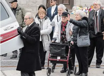  ?? RYAN REMIORZ THE CANADIAN PRESS ?? Family members wave goodbye as the casket of four-year-old Jacob Gauthier is put in the hearse after funeral services Thursday in Laval, Que. Gauthier was one of two children killed when a bus crashed into their daycare centre.
